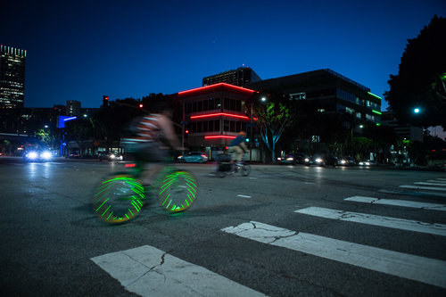 evening photo in downtown los angeles with lighted bicycle